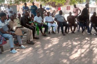 Honourable Kennedy Angbo sits with Ogyoma community members during the inspection visit.